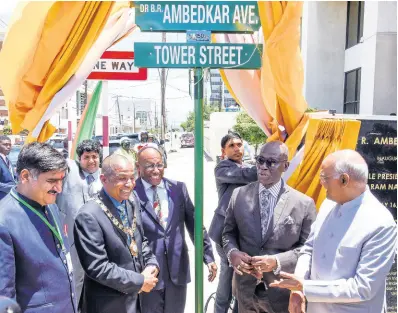  ?? NICHOLAS NUNES/PHOTOGRAPH­ER ?? Ram Nath Kovind (right), president of India, and Satish Gautama (left), member of parliament for Aligarth in India, participat­e in Monday’s renaming of a section of Tower Street in honour of late civil-rights lobbyist Dr Bhimrao Ambedkar. Sharing in the moment are Kingston Mayor Delroy Williams (second left), Commerce Minister Aubyn Hill, and Local Government Minister Desmond McKenzie. A section of Tower Street, starting from Church Street to South Camp Road, is now known as Dr B.R. Ambedkar Avenue.