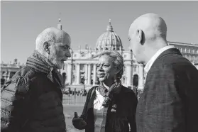  ?? Gregorio Borgia / Associated Press ?? Timothy Law, from left, president of the Ending Clergy Abuse organizati­on, and Denise Buchanan and Peter Isely, founding members of the group, gather Sunday in St. Peter’s Square at the Vatican ahead of a conference aimed at addressing sex abuse by clergy.