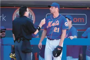  ?? JEFF ROBERSON/AP ?? New York Mets starting pitcher Max Scherzer talks with home-plate umpire David Rackley after working during the second inning of Sunday’s spring training game against the Washington Nationals in Port St. Lucie, Florida.