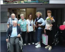  ??  ?? Assistant Director Of Nursing Nuala Gallager along with staff and residents presenting Volunteer Eileen Higgins and her dog Poppy with gifts.