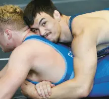 ?? ?? Ukrainian wrestler Vladlen Kozliuk, top, puts a hold on American wrestler Christian Carroll, of Osceola, Indiana.