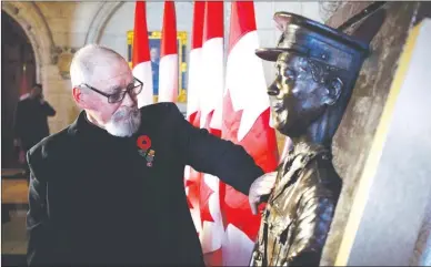  ?? The Canadian Press ?? Artist Tyler Briley, of Port Perry, Ont., looks at his work which is a sculpture an plaque honouring Lieutenant-Colonel Sam Sharpe as it is unveiled in the Foyer of the House of Commons on Parliament Hill in Ottawa on Wednesday.