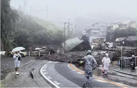  ?? SATORU WATANABE AP ?? A road is covered by mud and debris following heavy rain in Atami city, Shizuoka prefecture, on Saturday after a powerful mudslide carrying a deluge of black water and debris crashed into rows of houses following heavy rains.