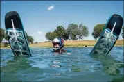  ??  ?? American-Statesman writer Pam LeBlanc floats in the waters of the Aquaplex ski lake in Martindale after attempting her first water ski jump.