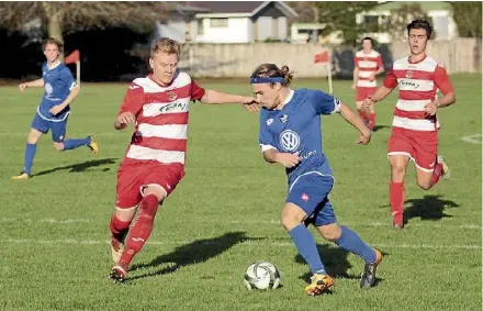  ??  ?? Devon Williams tries to stop Jonas Bucher attacking for Taupo, at Gower Park in Hamilton on Saturday. The final score, 0-0.