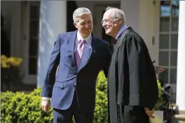  ?? AL DRAGO / THE NEW YORK TIMES ?? Supreme Court Justices Neil Gorsuch (left) and Anthony Kennedy stand in the Rose Garden of the White House in Washington.