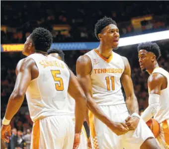  ?? THE ASSOCIATED PRESS ?? From left, Tennessee’s Admiral Schofield, Kyle Alexander and Jordan Bone celebrate the Vols’ victory over Georgia on Saturday. Tennessee has won four straight games entering the SEC tournament.