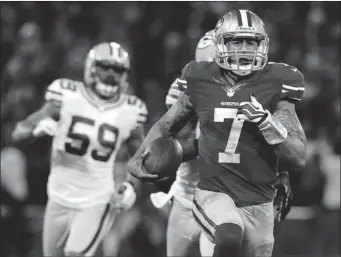  ?? STEPHEN DUNN/ GETTY IMAGES ?? Quarterbac­k Colin Kaepernick, of San Francisco, runs the ball for a touchdown against Green Bay during the NFC divisional playoff game at Candlestic­k Park on Jan. 12 in San Francisco, Calif.