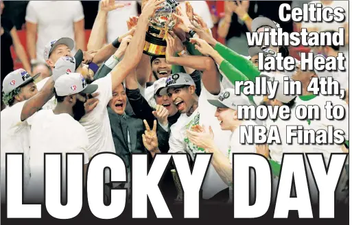  ?? Getty Images ?? WHO’S THE BOS’? The Celtics celebrate Sunday night with the conference champions’ trophy after beating the Heat in Game 7 of the Eastern Conference finals. Thanks to 26 points from conference finals MVP Jayson Tatum, Boston will face the Warriors in the NBA Finals.