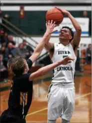  ?? RANDY MEYERS — THE MORNING JOURNAL ?? Elyria Catholic’s Dorian Crutcher hits the jump shot for two over Dallas Zollars of Wickliffe during the second quarter.