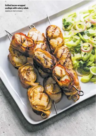  ?? AMERICA’S TEST KITCHEN ?? Grilled bacon-wrapped scallops with celery salad.