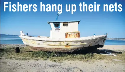  ?? PHOTOS: ALEXANDROS AVRAMIDIS/REUTERS ?? Cast aside . . . A boat awaits destructio­n at the port town of Ierissos.