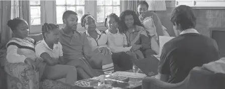  ?? WARNER BROS. PICTURES ?? The Williams family – from left, Isha (Daniele Lawson), Serena (Demi Singleton), Richard (Will Smith), Oracene (Aunjanue Ellis), Venus (Saniyya Sidney), Tunde (Mikayla Bartholome­w) and Lyndrea (Layla Crawford) – meets with tennis coach Rick Macci (Jon Bernthal), right, in a scene from “King Richard.”