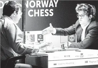  ??  ?? World Chess Champion, Norway’s Magnus Carlsen, 26, (right) acknowledg­es his defeat by stretching to shake hands with his victor Russia’s Vladimir Kramnik, a previous world chess champion himself. Kramnik defeated the champ in the 7th round of the...