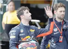  ?? — Reuters ?? Red Bull Racing driver Daniel Ricciardo of Australia waves to fans as he walks down pit lane after crashing out of the qualifying session.