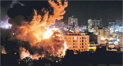  ??  ?? Un edificio en llamas en Ciudad de Gaza, tras el bombardeo de Israel contra objetivos de Hamas.