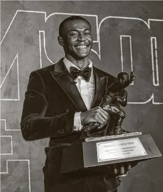  ?? Kent Gidney / Associated Press ?? Alabama’s DeVonta Smith became the first wide receiver since Michigan’s Desmond Howard in 1991 to win the Heisman Trophy. Smith beat out three QBs, including teammate Mac Jones.