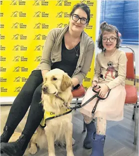  ?? Susan Melendy Stark, Rhea Stark, and Rhea’s buddy dog, Ivy. Ivy was one of two dogs to graduate on Friday. ANDREW WATERMAN/THE TELEGRAM ??