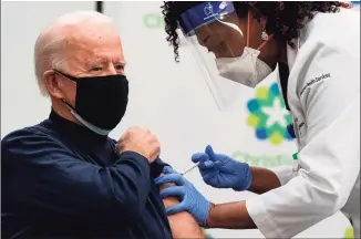  ?? Alex Edelman / TNS ?? President-elect Joe Biden receives a COVID-19 vaccinatio­n from Tabe Masa, nurse practition­er and head of Employee Health Services, at the Christiana Care campus in Newark, Del., on Monday.
