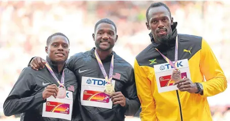  ?? Picture: Getty. ?? Justin Gatlin, centre, with silver medallist Christian Coleman, left, and third-placed Usain Bolt.