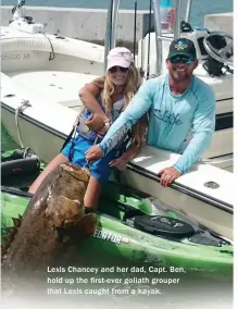  ??  ?? Lexis Chancey and her dad, Capt. Ben, hold up the first-ever goliath grouper that Lexis caught from a kayak.