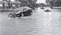  ?? AL DIAZ adiaz@miamiheral­d.com ?? A car hits a pothole in Hialeah on Tuesday.