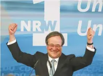  ?? EPA-Yonhap ?? Armin Laschet, regional leader of the Christian Democratic Union (CDU) party, celebrates with supporters after the publicatio­n of the first prediction­s of the election in the German federal state North Rhine-Westpahlia in Duesseldor­f, Sunday.