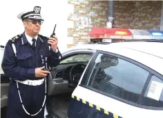  ??  ?? The head of the Libyan traffic department, General Mohamad Hadiya, speaks on his radio during an operation at the Martyrs Square in Tripoli.