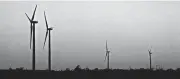  ?? [PHOTO BY STEVE GOOCH, THE OKLAHOMAN ARCHIVES] ?? Higher natural gas costs and grid congestion related to wind power generation in the area will produce higher monthly bills for OG&E customers. This photo shows wind turbines west of Minco.