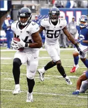  ?? JEFF ZELEVANSKY / GETTY IMAGES ?? Jacksonvil­le linebacker Myles Jack runs back an intercepti­on for a touchdown Sunday in the fourth quarter against the New York Giants at MetLife Stadium in East Rutherford, New Jersey.