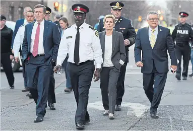  ?? NATHAN DENETTE/THE CANADIAN PRESS ?? From left to right, Toronto Mayor John Tory, Toronto police Chief Mark Saunders, Ontario Premier Kathleen Wynne and Ralph Goodale, Federal Minister of Public Safety and Emergency Preparedne­ss, walk together towards a news conference.