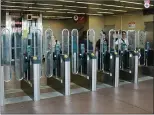  ?? COURTESY OF PORT AUTHORITY TRANSIT CORP. ?? Passengers pass through fare gates at the Lindenwold transit station in New Jersey. BART is considerin­g installing similar fare gates to cut down on fare evasion.