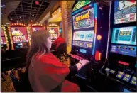  ?? NWA Democrat-Gazette/JASON IVESTER ?? Pam Thurman of Grove, Okla., plays on a machine at Cherokee Casino in Grove. In 2015 — the latest year available — gambling operations run by American Indian tribes for the first time bested other gambling segments.