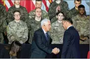  ?? SEAN GALLUP PHOTOS / GETTY IMAGES ?? Vice President Mike Pence shakes hands with Polish President Andrzej Duda before speaking at a military base on Wednesday in Warsaw, Poland.