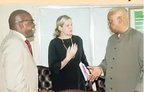  ??  ?? Minister of Youth, Sport, Arts and Recreation, Kirsty Coventry (centre) shares some notes with the visiting African Union Sports Council Region Five chairman Vetumbuavi Veii (right) and chief executive officer Stanley Mutoya (left) just before their meeting yesterday in Harare