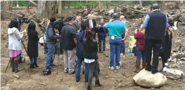  ?? RUSS STANTON/G.F.BUNTING VIA AP ?? Survivor and co-plaintiff Lalo Barajas, center, whose partner Peter Fleurat was killed during devastatin­g debris flows in January at their home, speaks at the site on Thursday in Montecito, Calif.