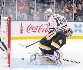  ??  ?? The Blackhawks’ Jonathan Toews, No.19, scores the winning goal against Boston.