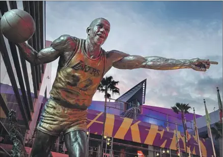  ?? MAGIC JOHNSON’S Brian van der Brug Los Angeles Times ?? statue is one of many dedicated outside Staples Center over the past 20-plus years in aptly named Star Plaza.