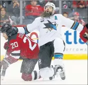  ?? NOAH K. MURRAY — THE ASSOCIATED PRESS ?? Sharks defenseman Brent Burns goes down after checking Devils center Blake Coleman (20) on Sunday.