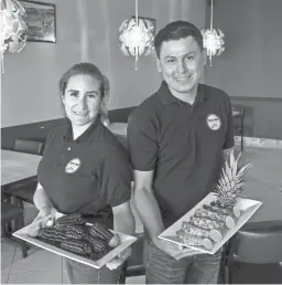  ??  ?? Douglas Sanguino and his wife, Clara, opened the restaurant Taste of Peru in January. They serve a homemade drink, chicha morada, a Peruvian purple corn drink, that takes three hours to make.