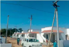  ??  ?? Workmen give final touches to the 2BHK houses on Thursday, as Erravalli residents prepare for housewarmi­ng function scheduled for Friday. — DC