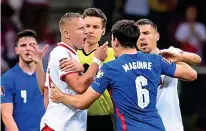  ?? GETTY IMAGES ?? Defenders do battle: Glik and Maguire clash at the break, leading to bookings for both