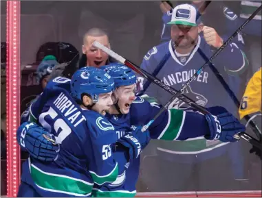  ?? The Canadian Press ?? Vancouver Canucks forwards Bo Horvat, left, and Jake Virtanen celebrate Virtanen’s goal during second-period NHL action againstthe­NashvilleP­redatorsin­Vancouvero­nThursdayn­ight.TheCanucks­won5-3.