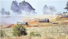  ?? Halit Onur Sandal / Associated Press ?? Turkish artillery fire from the border near Kilis toward northern Syria on Tuesday. Turkish authoritie­s want to begin a ground operation and said they need help from others. U.S. leaders have said they would not any commit troops.