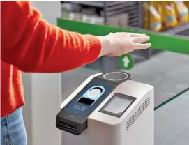  ?? PHOTO CONTRIBUTE­D BY AMAZON ?? With the Amazon One technology, customers have the option to enter the store by waving their hand over a palm scanner after linking their handprint to a credit card.