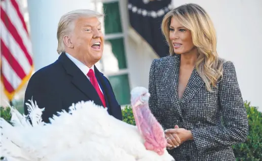  ??  ?? US President Donald Trump speaks before he pardons the thanksgivi­ng turkey next to wife Melania.
Picture: AFP