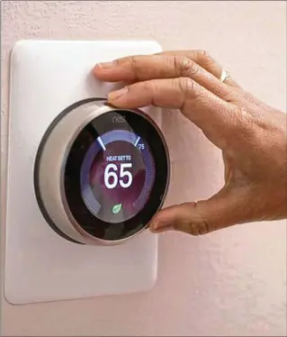 ?? JOHN KIM/CNET/TMS FILE ?? Georgia utilities recommend a thermostat setting of no warmer than 68 during cold weather. It saves money and puts less strain on your equipment. Too low? Wearing warm clothing inside helps.
