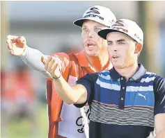  ??  ?? One idea that may provoke heated debate – especially on the LPGA Tour, where it is most prevalent – is forbidding caddies to help players line up putts. File photo shows Rickie Fowler of the United States talking with his caddie Joe Skovron on the 18th...