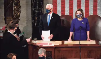  ?? Saul Loeb / Associated Press file photo ?? Vice President Mike Pence presides over a joint session of Congress as it convenes to count the Electoral College votes cast in November's election, at the Capitol in Washington on Jan. 6, 2021. Speaker of the House Nancy Pelosi, D-Calif., stands at right.