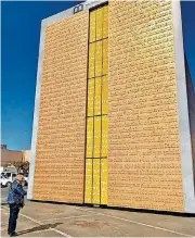  ?? [PHOTO BY CARLA HINTON, THE OKLAHOMAN] ?? Inez Freeman, of Bethany, walks up to the Museum of the Bible’s Gutenberg Gates replica on Oct. 28 at Penn Square Mall in Oklahoma City.